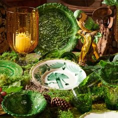 a table topped with lots of green dishes