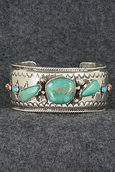 "This stunning and substantial turquoise, coral and sterling silver bracelet was made by Navajo silversmith Emerson Delgarito. The inside is signed E. Delgarito and stamped sterling. Size: 5 3/8\" (will fit up to a 6 1/2\" wrist) Gap: 1 1/8\" Length: 1 1/8\" Free shipping on all orders! We ship with USPS and always include tracking. All orders ship within a day of payment. Returns are accepted up to 30 days after you receive your order. Just send us a message. Our shop offers cash back or store Southwestern Style Bracelet With Polished Finish, Engraved Turquoise Sterling Silver Bracelet Gift, Bohemian Turquoise Sterling Silver Bangle, Adjustable Turquoise Southwestern Cuff Bracelet, Southwestern Sterling Silver Inlay Bracelet Gift, Southwestern Silver Bracelet With Multi-stone, Southwestern Silver Multi-stone Bracelet, Southwestern Silver Multi-stone Bracelets, Unique Turquoise Nickel-free Bracelets