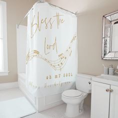 a bathroom with a shower curtain that says, blessing the lord oh my soul