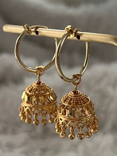 Traditional Gold Metal Clip-on Earrings, Traditional Metal Dangle Clip-on Earrings, Festive Brass Hoop Earrings With Latkans, Festive Gold Plated Hoop Earrings, Festive Gold Plated Dangle Hoop Earrings, Gold Plated Jhumkas With Latkans, Gold Plated Dangle Jhumkas With Latkans, Festive Gold Metal Hoop Earrings, Elegant Hoop Danglers With Latkans