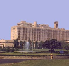 a large building with a fountain in front of it