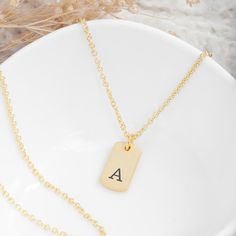 A timeless piece of jewellery that adds a personal touch to any collection; she'll love our sensational Monogrammed Gold Tag Necklace. Whether you're searching for the ideal birthday, Christmas, or Valentine's gift, this elegant necklace is a meaningful way to show her your love and appreciation. This gold necklace features a customisable plated tag which can be engraved by our specialist team with an initial, creating a unique and meaningful present that she's sure to treasure forever. Its mini Gold Tag Necklace, Watch Locket, Gold Tag, Jewelry Lockets, Elegant Necklace, Valentine's Gift, Valentines Gifts For Her, Childrens Jewelry, Elegant Necklaces