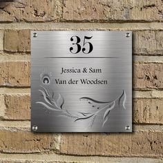 a metal plaque on the side of a brick wall reads, 35 jessica & sam van der woodsen