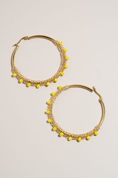 Add a touch of color to your look with these cute hoops, handcrafted using the intricate macrame technique. Each pair features beautiful beads that create an understated color statement, making these earrings a must-have addition to any jewelry collection. Lightweight and versatile, they pair perfectly with any outfit, whether you're dressing up for a special occasion or adding a chic touch to your everyday style. These earrings are a staple item, embodying both craftsmanship and contemporary fa Adjustable Macrame Beaded Earrings, Bohemian Yellow Hoop Earrings, Wire Wrapped Hoop Beaded Earrings, Yellow Adjustable Beaded Hoop Earrings, Small Yellow Beaded Hoop Earrings, Yellow Beaded Small Hoop Earrings, Yellow Beaded Round Hoop Earrings, Yellow Beaded Small Hoop Jewelry, Yellow Hoop Earrings With Dangling Beads