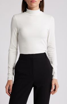 Sleek and streamlined, this long-sleeve mock-neck top is a wardrobe staple that you can wear absolutely anywhere. 23 1/2" length Mock neck Long sleeves 100% viscose Machine wash, line dry Made in Portugal Minimal Stretch Winter Tops For Work, Elegant Mock Neck Top For Work, Classic Turtleneck Top For Business Casual, Long Sleeve Turtleneck For Work In Spring, Long Sleeve Turtleneck For Spring Workwear, Elegant Mock Neck Top For Workwear, Solid Color Long Sleeve Mock Neck Top For Work, Spring Long Sleeve Turtleneck For Work, Sleek Long Sleeve Turtleneck For Fall