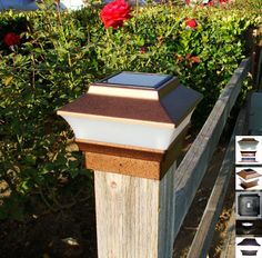 a wooden post with a solar powered light on top and some flowers in the background