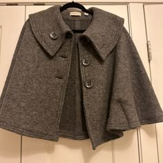 Super Cute Cape/Jacket Size: S/M 80% Wool, 20% Polyester No Stains, Rips Or Smells Excellent Condition And Barely Worn Classic Winter Cape Outerwear, Workwear Cape Outerwear With Button Closure, Workwear Cape With Button Closure, Fitted Cape Outerwear For Work, Fitted Cape For Workwear, Winter Fitted Capelet, Fitted Winter Capelet, Fitted Fall Cape For Workwear, Fitted Cape For Fall Workwear