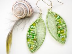 Light green spring earrings Nature inspired jewelry Leaves earrings Peridot green lightweight earrings Wedding bridal earrings Bohemian These interesting earrings of leaves motif are made using light green colored copper wire and different shades of green seed beads and tubes which makes the jewelry more easy to combine with your outfit. I put great focus on precise wrapping of the wire so that it does not falters anywhere. Jewelry is comfortable to wear and lightweight. Specifics: * earrings ar Green Bohemian Earrings For Wedding, Bohemian Green Earrings For Wedding, Bohemian Green Bridal Earrings For Wedding, Green Beaded Earrings For Wedding, Elegant Wire Wrapped Earrings For Summer, Elegant Summer Wire Wrapped Earrings, Green Bohemian Jewelry For Spring, Green Leaf-shaped Jewelry With Matching Earrings, Bohemian Green Wrap Earrings Gift