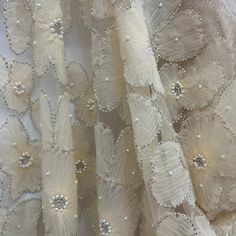 Make a statement with amazing, beaded 3D lace fabric! This luxurious fabric is perfect for creating high-end pieces for any special occasion. Our exquisite 100% polyester net mesh is intricately embroidered with a beautiful, beaded 3D floral design, making it a stunning choice for couture 3D bridal lace, evening dress 3D lace, quinceanera dress 3D lace, dance costume 3D lace and any other fabulous special occasion piece. Perfect for adding a couture touch to your look, this beaded 3D lace fabric Elegant Tulle Fabric With 3d Lace Embroidery, Elegant Lace Fabric With 3d Embroidery, Luxury Lace Tulle Fabric With Pearl Embroidery, Luxury Blue Embroidered Lace Fabric, Beige Pearl Embroidered Lace Fabric, Floral Lace Fabric, Beaded Lace Fabric, Quinceanera Dress, Dance Costume