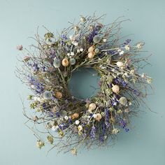 a wreath with dried flowers on a blue background