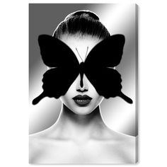 a woman's face with a butterfly on her head and the image is black and white