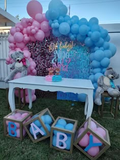 a baby shower party with balloons and teddy bears on the grass in front of a table