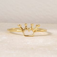 "Discover the dainty of our handcrafted in queen crown 10 K, 14 K or 18 K solid real gold, tailored to your preferences. Customers adore our handmade minimalist style custom & personalized engagement, promise, and \"she said yes\" rings, perfect for special occasions such as weddings, bachelorette parties, remembrances, bridal showers, thank-yous, and holidays like Thanksgiving, Mothers Day, Christmas, Valentine's Day, anniversary, summer, winter, fall, Halloween, just because, Thanksgiving, Bla Elegant Crown Design Jewelry For Birthday, Elegant 14k Gold Rings For Birthday, Elegant Gold Birthday Rings, Elegant Round Crown For Gift, Elegant Gold Rings For Birthday, Adjustable Crown Design Jewelry, Anniversary Crown Shaped 14k Gold Ring, Elegant Gold Crown With Pinched Shape, Gold Crown For Gift With Structured Shape