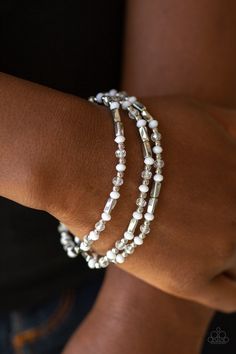 A dainty collection of faceted white beads, dainty silver beads, silver rectangular accents, and crystal-like beads are threaded along stretchy bands around the wrist for a colorful look. Sold as one set of three bracelets. Get The Complete Look! Necklace: "Mainstream Minimalist - White" (Sold Separately) White Bracelet, White Bracelets, Paparazzi Accessories, Stretchy Bracelets, Paparazzi Jewelry, White Beads, One Set, Accessories Jewelry, White Silver