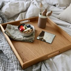 a bowl of fruit and yogurt on a tray