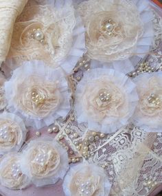 several pieces of fabric and lace with flowers on them