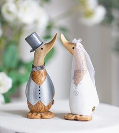 two wedding figurines, one with a veil and the other wearing a top hat