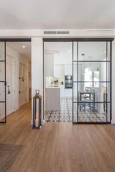 an open living room and dining area with glass doors