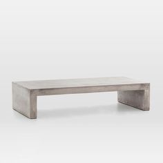 a concrete bench sitting on top of a white floor