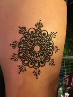 the back of a woman's thigh with a henna tattoo on it