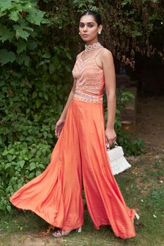 Tangerine orange sleeveless jumpsuit crafted in chanderi cotton silk with synodic embroidery on the yoke using sequins, beads and cutdana highlights. - Aza Fashions Orange Embellished Party Sets, Festive Floor-length Jumpsuits And Rompers For Summer, Festive Orange Embellished Sets, Festive Party Sets With Embroidered Neckline, Sleeveless Orange Set For Festive Occasion, Sleeveless Embellished Summer Set, Orange Sleeveless Festive Set, Embellished Sleeveless Summer Sets, Summer Sleeveless Embellished Set