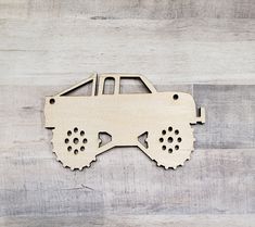 a laser cut out of a toy car on a wooden background with space for text