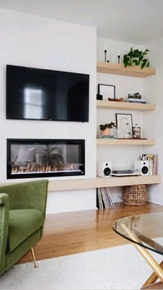 a living room filled with furniture and a flat screen tv mounted on the wall above a fire place