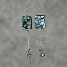 These unique dangling statement earrings are handmade using abalone shell and Czech glass. Perfect gift for any occasion! Free U.S shipping! Anni Designs. The shells of abalones is highly iridescent. The ever changing colors is mesmerizing and mysterious. The dazzling color palette of green, purple, blue and a touch of peach, strikes a balance between extroverted yet peaceful. The length of the earrings is 2 1/4 inches, 56mm. (excluding the length of hook) For matching bracelet, please go to: ht Elegant Handmade Iridescent Earrings, Elegant Iridescent Crystal Earrings Gift, Handmade Long Drop Pearl Earrings For Gifts, Handmade Long Drop Pearl Earrings As Gift, Mother Of Pearl Dangle Earrings For Party, Iridescent Mother Of Pearl Dangle Jewelry, Party Mother Of Pearl Dangle Earrings, Abalone Shell Earrings For Pierced Ears As A Gift, Gift Abalone Shell Earrings For Pierced Ears