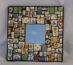 a square shaped mirror with many different designs on it