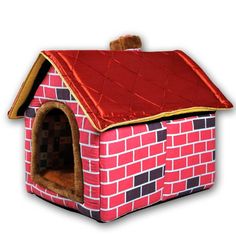 a pink dog house with a red roof