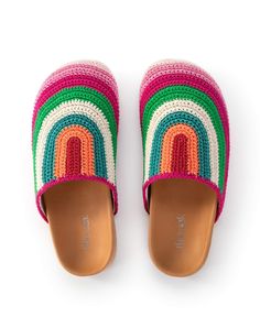 a pair of slippers with multicolored stripes on them sitting on top of a white surface