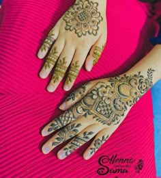 two hands with henna tattoos on them