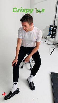 a man sitting on top of a chair in front of a white wall with the words crispy fix