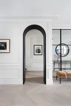 an archway between two white walls in a room