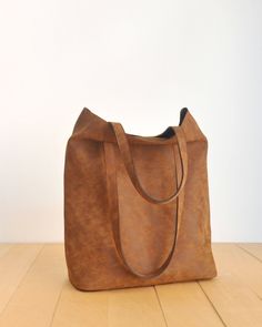 "This tote bag is made of high quality vegan leather in brown. It is soft and lightweight but durable. It has a rustic, distressed look. It has two interior pockets. It has a slouchy silhouette and plenty of room for your daily needs. Measurements: 41 x 31 x 14 cm IMPORTANT! Your orders between 7-25 August will be shipped on August 28. Delivery takes 2-5 days to the US, Canada, Australia and Europe; in 3-7 days to rest of the world after shipping. For other color options you can check \"Totes\" Brown Large Capacity Softback Bag, Versatile Square Brown Hobo Bag, Versatile Brown Rectangular Satchel, Brown Satchel With Large Capacity, Versatile Brown Tote Bag, Brown Softback Satchel With Large Capacity, Leather Softback Shoulder Bag For On-the-go, Everyday Square Brown Shoulder Bag, Everyday Brown Square Shoulder Bag