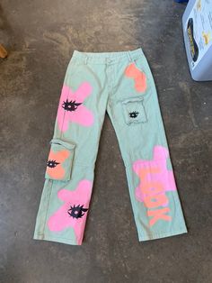 These pants are hand dyed and screen printed on. It was made in my undergrad as one of the pieces of my thesis show. Labor was intensive but I loved every minute of it. The sizing is a larger medium or a smaller large. I hope you love them as much as I do :) Grunge Cotton Pants With Graphic Print, Screen Printed Jeans, Pink Graphic Print Pants For Streetwear, Trendy Cotton Pants With Graphic Print, Acid Wash Hand Dyed Cotton Pants, Trendy Cotton Bottoms With Graffiti Print, Spring Cotton Pants With Graffiti Print, Hand Dyed Acid Wash Cotton Pants, Artistic Cotton Bottoms With Graphic Print