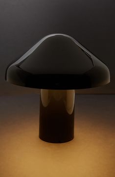 a black table lamp sitting on top of a white floor