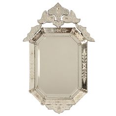 an ornate silver framed mirror on a white background