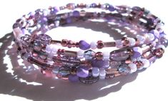 Some days  just call for purple. Wrap your wrist in five sparkling rings of purple in every shade: violet, lavender, lilac and the deep, dark color of purple rain. All glass and crystal beads.  The beads are strung on medium sized oval memory wire - the oval shape is much more comfortable than circular memory wire. ElephantBead memory wire beaded bracelets can be ordered in two sizes: - Small: Fits a small adult wrist of 5.0 - 6.5 inches - Medium: Fits a medium adult wrist of 6.5 - 8 inches (sho Lavender Bracelets With Spacer Beads As Gift, Lavender Bracelets With Spacer Beads For Gift, Purple Beaded Bohemian Wrap Bracelet, Purple Beaded Bracelet With Spacer Beads As Gift, Purple Beaded Bracelets With Spacer Beads As Gift, Adjustable Purple Beaded Bracelets With Spacer Beads, Adjustable Lavender Bracelets With Spacer Beads, Handmade Purple Wrap Bracelet As Gift, Elegant Purple Bracelets With Colorful Beads