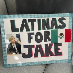 there is a sign that says latinas for jake on the back of a couch