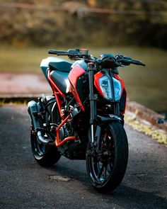 a red and black motorcycle parked on the street