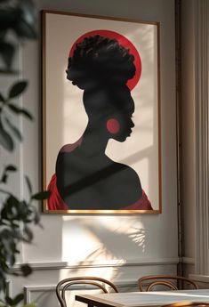 an image of a woman's profile on a wall above a table in a restaurant