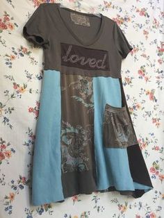 a women's t - shirt dress with patches on it