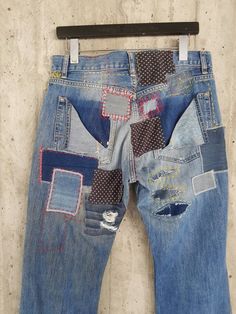 an old pair of jeans with patches on them