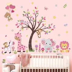 a baby's room with pink walls and wall decals