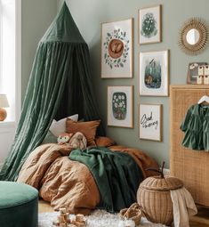 a bedroom with green walls and pictures on the wall