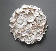 a white flower arrangement on a gray surface