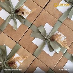 some brown and white boxes wrapped in green ribbon