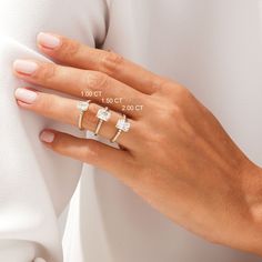 a woman's hand with three rings on her finger and the words 1010 00 00 00 00