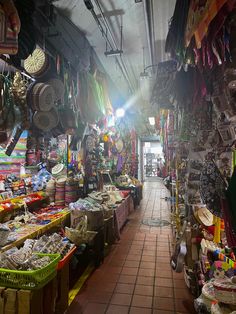 the inside of a market with lots of baskets and other items on display for sale